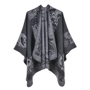 Detail of grey and black paisley pattern on thick knitted poncho cape shawl for women