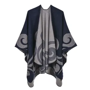 Detail of navy and grey reversible knit shawl with classic jacquard floral pattern