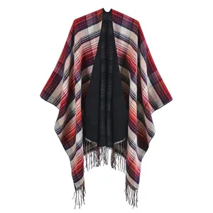 Close-up of tartan pattern shawl with soft fringe trim and black inner lining