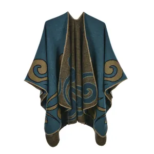 Detail of teal and tan knit poncho showing fine stitching and scrolled patterns