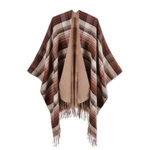 Detail of classic plaid shawl with fringe edges and warm faux cashmere texture