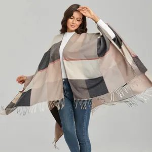 Close-up of vintage check pattern shawl with long tassel fringe and soft wool texture