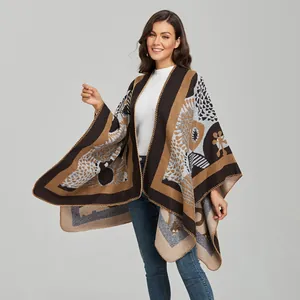 Detail of a thick knitted women's poncho featuring vintage abstract geometric patterns
