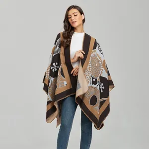 Close-up of elegant vintage floral knit shawl with geometric pattern and split front