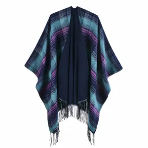 Detailed close-up of navy blue plaid shawl fringe and soft cashmere-like texture