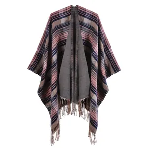 Detail of Scottish plaid shawl featuring pink and brown fringes and thick knit texture