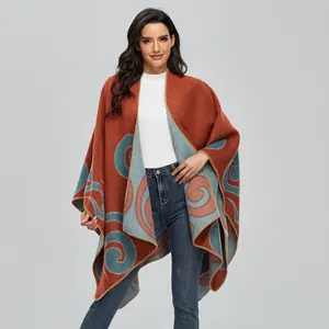 Women's warm cashmere-like poncho shawl with orange and blue abstract swirl patterns