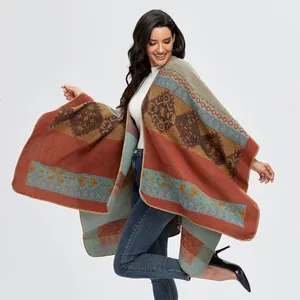 Detail of bohemian knit shawl showing intricate geometric patterns and tassel trim edges