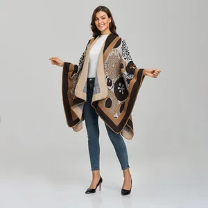 Women's knit poncho wrap with floral patterns and color-blocking aesthetic
