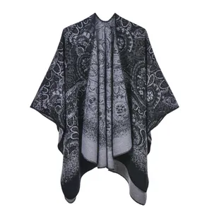 Detail of vintage paisley knit shawl showing black and grey pattern and edge stitching