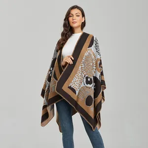 Detailed view of the intricate knit pattern and geometric jacquard fabric on the poncho