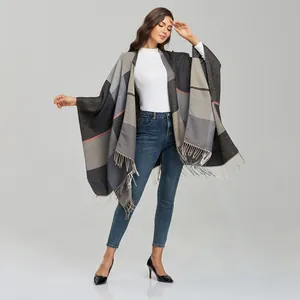 Detail shot of the jacquard checkered shawl featuring soft fringe trim and thick texture
