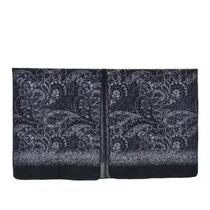 Detailed view of paisley patterns and texture on a warm thick winter poncho shawl