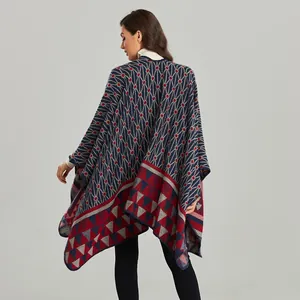 Women's knit poncho cape with geometric patterns and fringe detail in navy blue