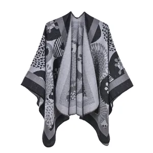 Detailed view of gray and black geometric floral knit texture on women's poncho cape