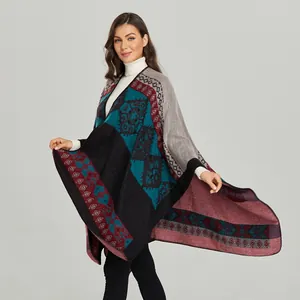 Detailed view of vintage geometric knit pattern on soft burgundy and navy cashmere poncho