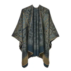 Detail of vintage paisley pattern on thick knitted winter poncho with fine edge stitching