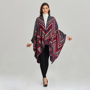 Detailed knit texture of a bohemian geometric print split shawl poncho in navy and burgundy