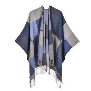 Close-up detail of geometric navy blue and grey jacquard shawl with tassel fringe