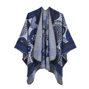 Close-up of knit fabric texture and floral pattern on women's navy blue poncho shawl