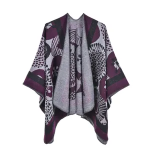 Detailed view of heavy knit poncho with purple floral jacquard patterns and gray stripes