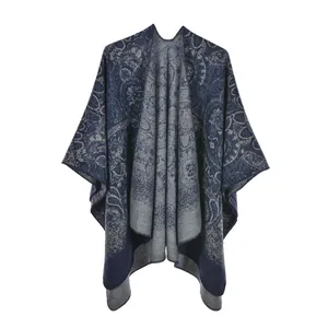 Detail of blue and grey paisley knit shawl with reversible jacquard pattern and curved hem