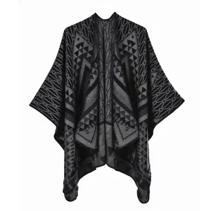 Detail of bohemian knit shawl with grey and black geometric jacquard patterns