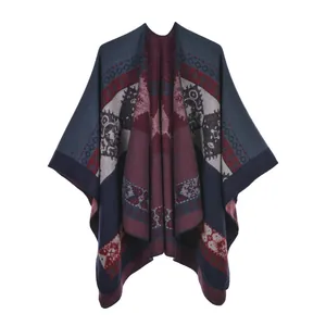 Detailed view of ethnic knit poncho with vintage geometric patterns and fringe detail