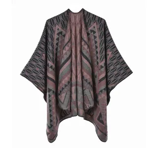 Close-up of bohemian knit shawl with ethnic geometric patterns in dark red and grey
