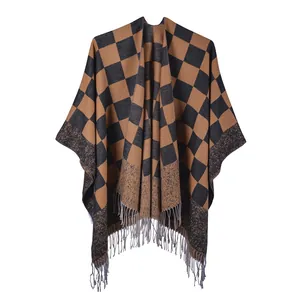Detail of classic checkerboard knit shawl with fringe hem and soft winter fabric