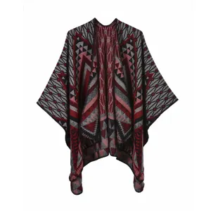 Detailed view of thick knitted shawl featuring red and grey geometric triangle patterns