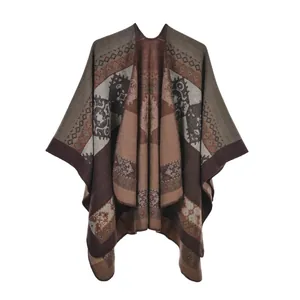 Detail of bohemian knit shawl featuring ethnic geometric patterns and rich fringe