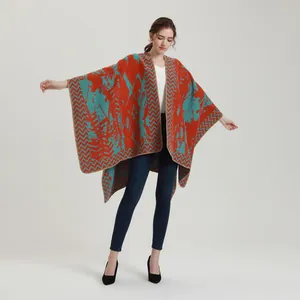 Close-up of thick knit shawl texture and vibrant orange blue abstract geometric patterns