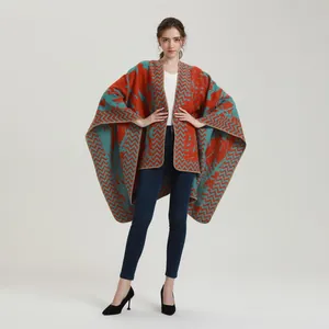 Detail of the rust red and blue wavy knit pattern on a thick oversized warm shawl