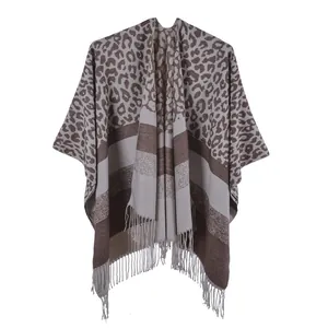 Detail showing high-quality leopard print knit shawl with fringe and soft texture