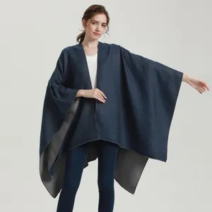 Deep blue cashmere-like poncho shawl with grey lining and loose open-front drape style