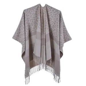 Detail of grey leopard print shawl featuring knit texture and soft fringe trim