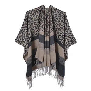 Close-up of leopard print knit shawl with fringe edge and striped bottom texture