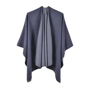 Detail of dark grey knit texture and asymmetric drape on a soft pashmina shawl