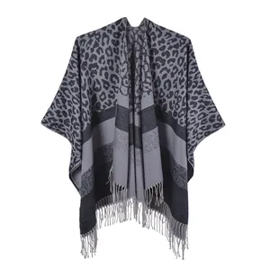 Detail of soft leopard print shawl with grey stripes and fine tassel trim decor