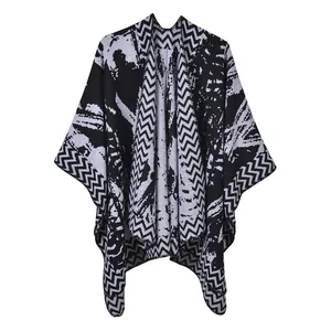 Detail of knit shawl featuring black and white zigzag patterns and abstract textures