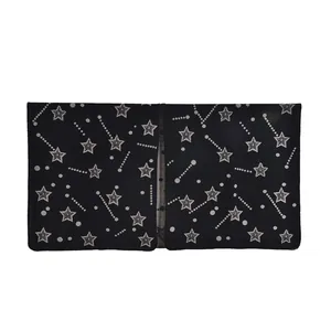 Detail shot of black knitted shawl featuring white star patterns and shooting star motifs