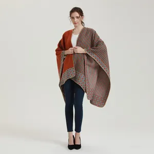 Close-up of vintage ethnic shawl with orange and blue-grey striped geometric diamond patterns