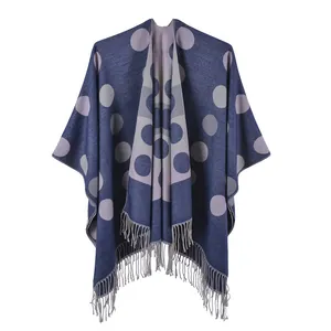 Detail of navy blue knitted shawl with large purple polka dots and fringe hem