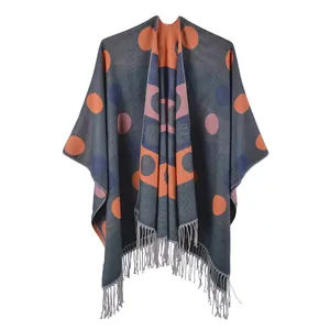 Women's dark grey cashmere-like poncho with colorful polka dots and fringe details