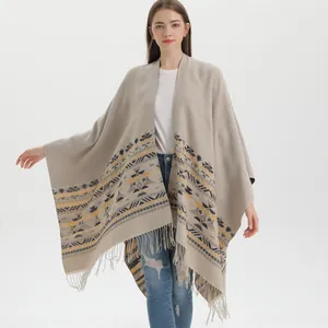 Women's bohemian knit poncho shawl with geometric patterns and tassel hem fringe
