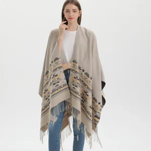 Bohemian knitted poncho cape with geometric ethnic patterns and fringe detail