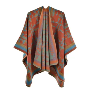 Detail of vintage red knit poncho shawl with bohemian patterns and finished edges