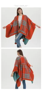 Detail of soft thick cashmere-like poncho showing orange and blue plaid texture
