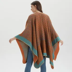 Close-up of thick knit fabric with geometric diamond patterns on a warm winter poncho